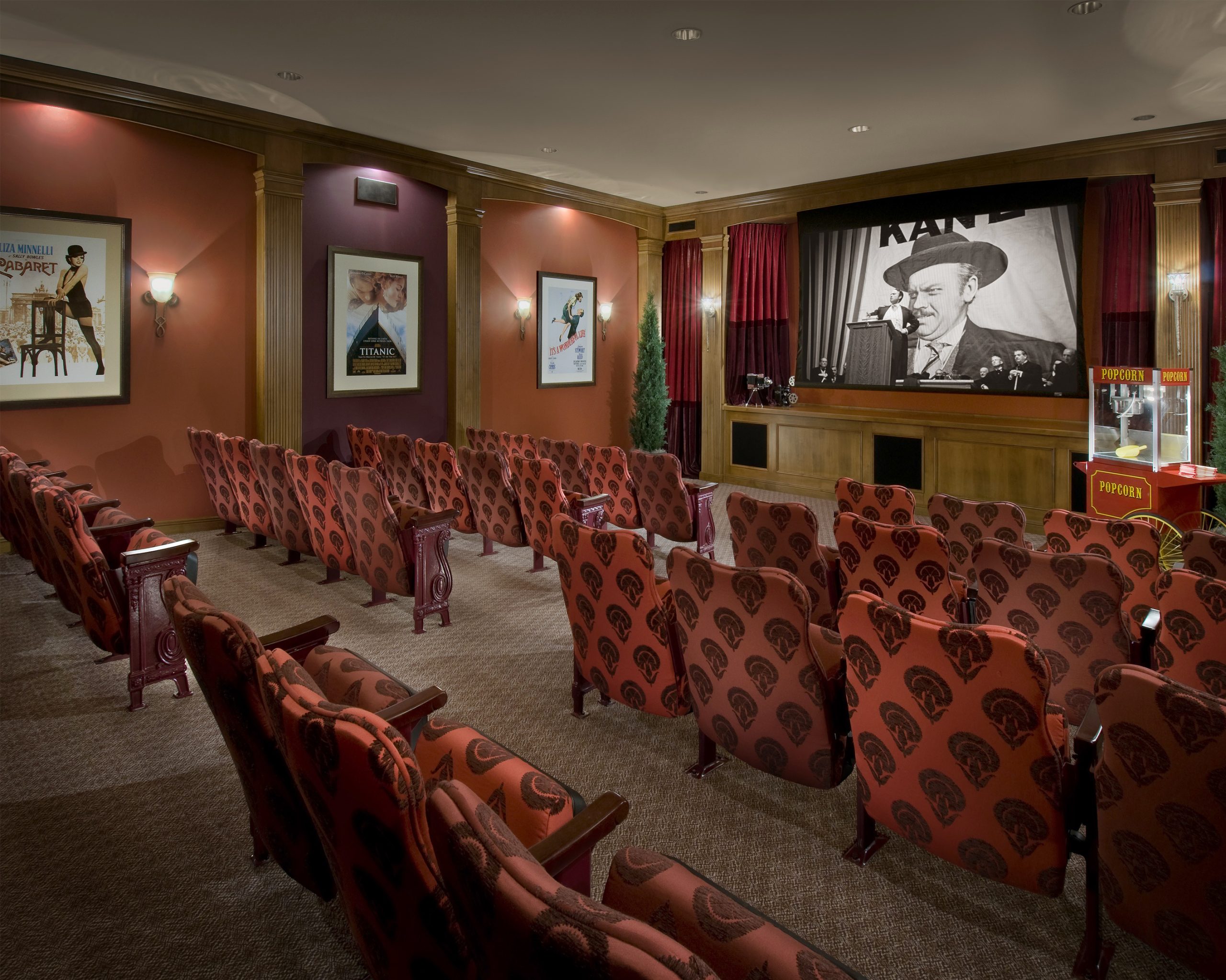 a large movie theatre with red fabric on the seats