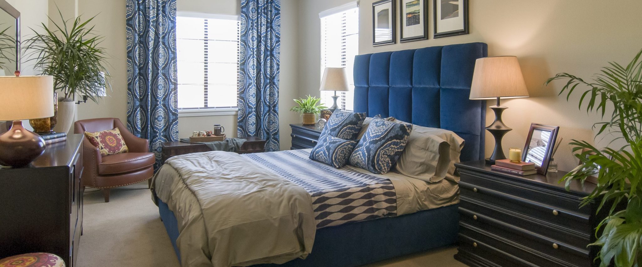 A bedroom with a blue and white decor featuring a cozy bed 