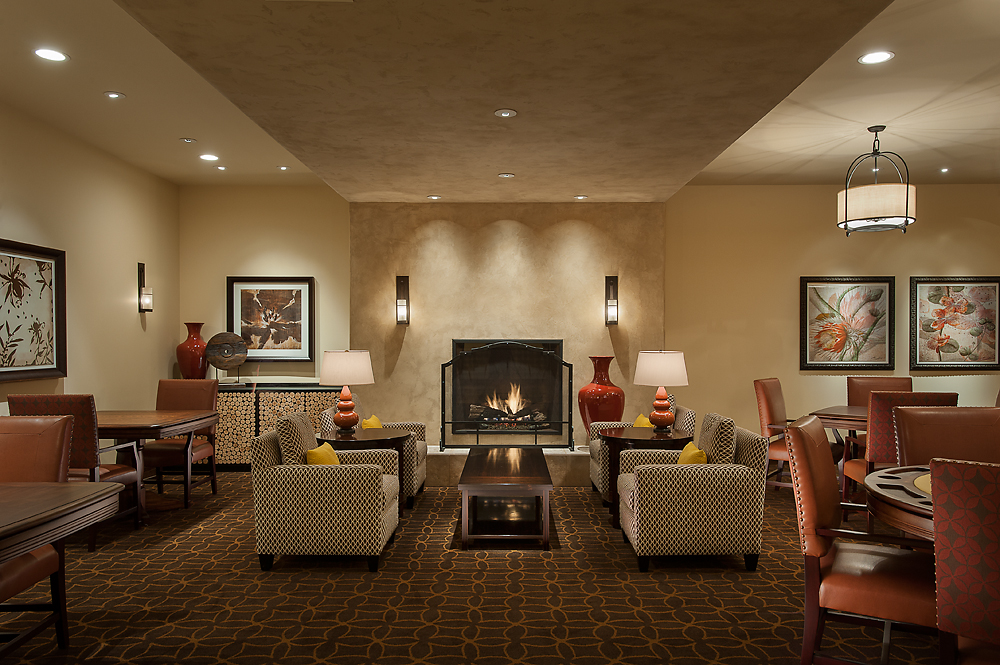 games and card room at retirement community, with ample seating and a fireplace
