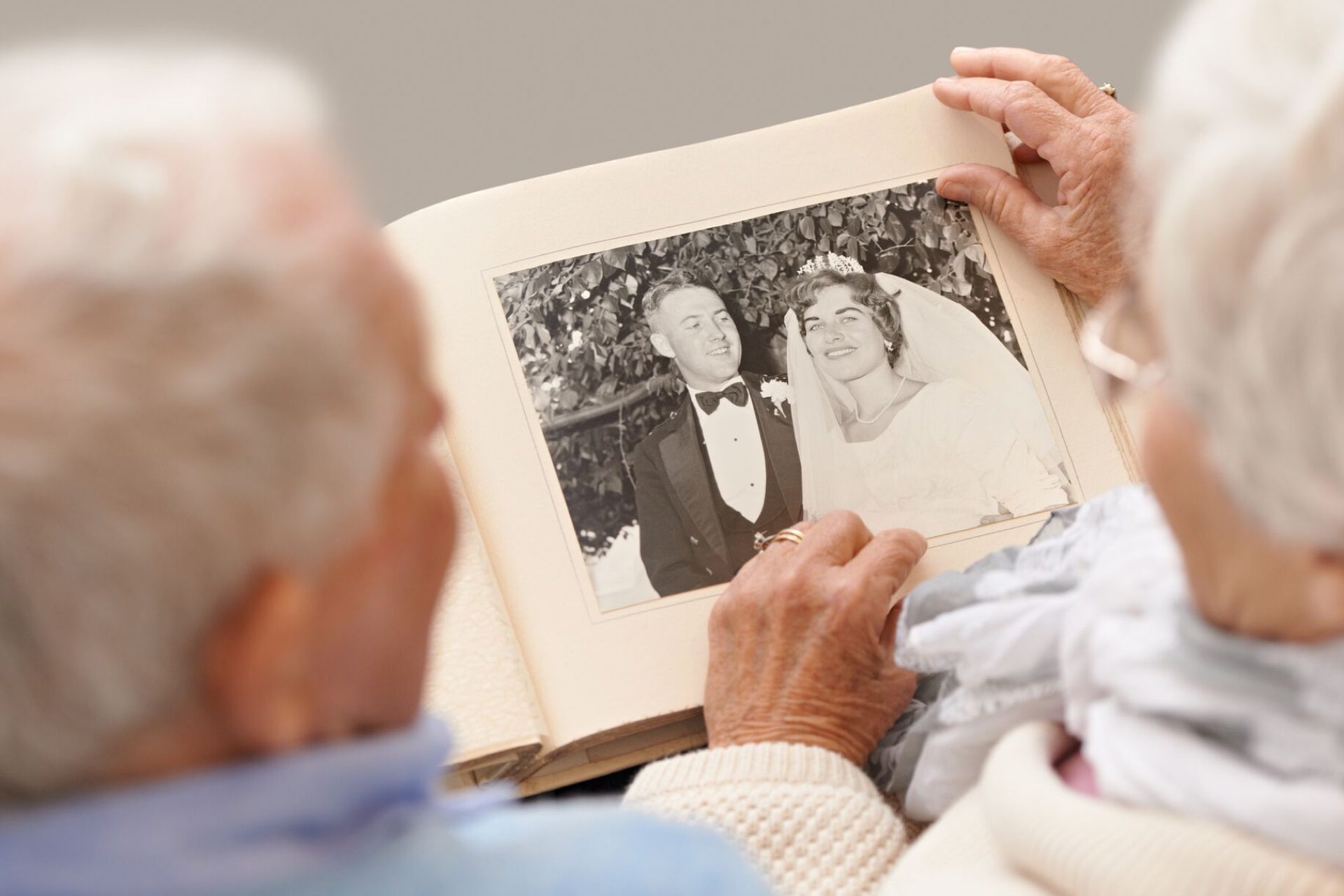 Residents looking at old black and white wedding photograph