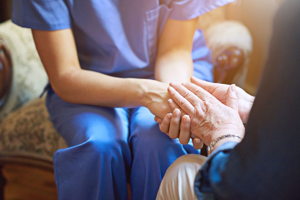 Nurse holding resident's hands
