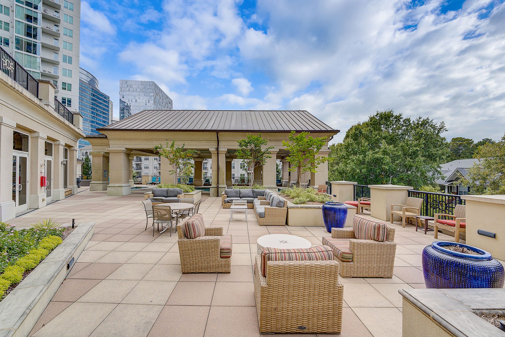 A city view from a patio with furniture.