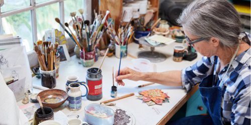 elderly woman expressing her creativity by painting