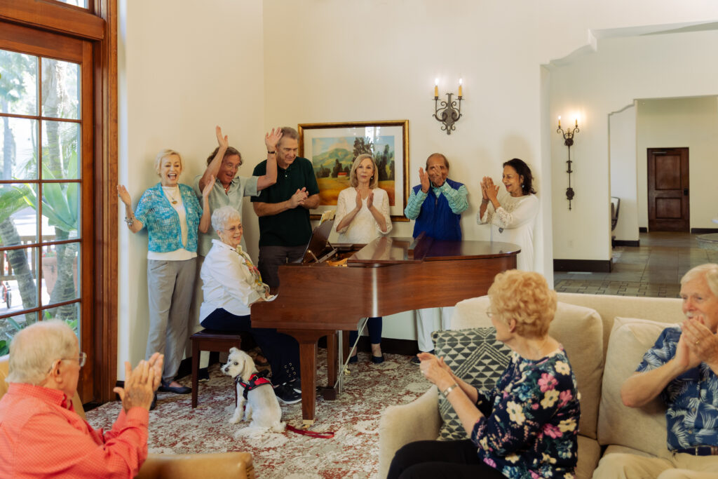 Seniors around a piano