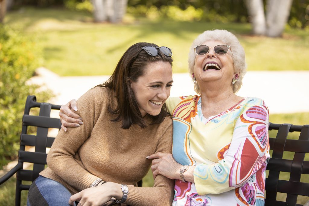 2 women sitting on a bench