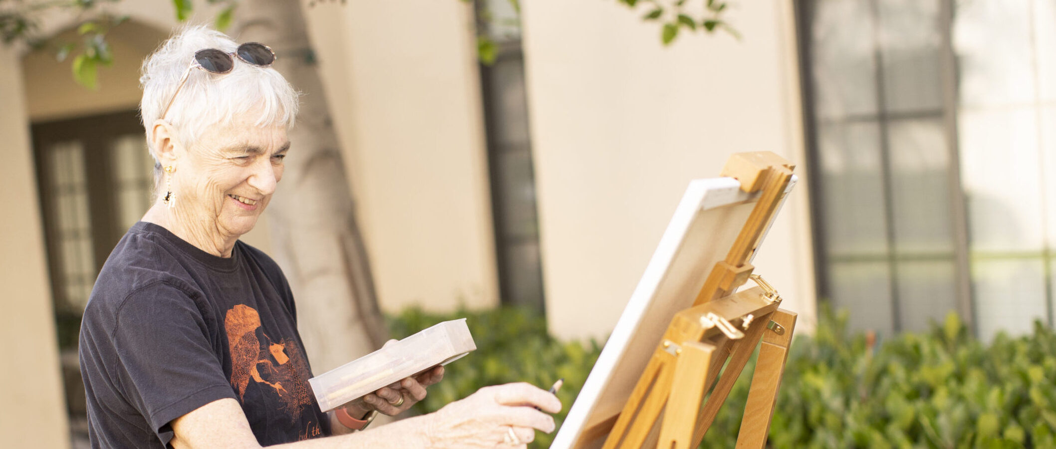 Senior woman painting on canvas