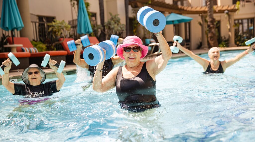A group of people enjoying a pool, using water dumbbells for exercise and relaxation.