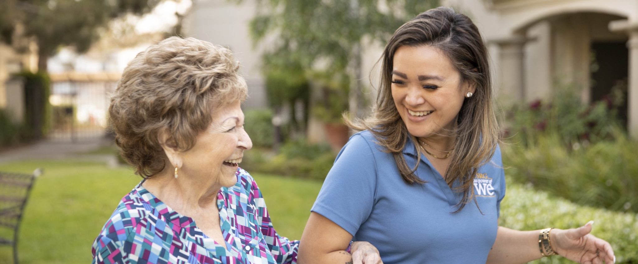 A woman and an older woman walking together sharing a bond of companionship and support 