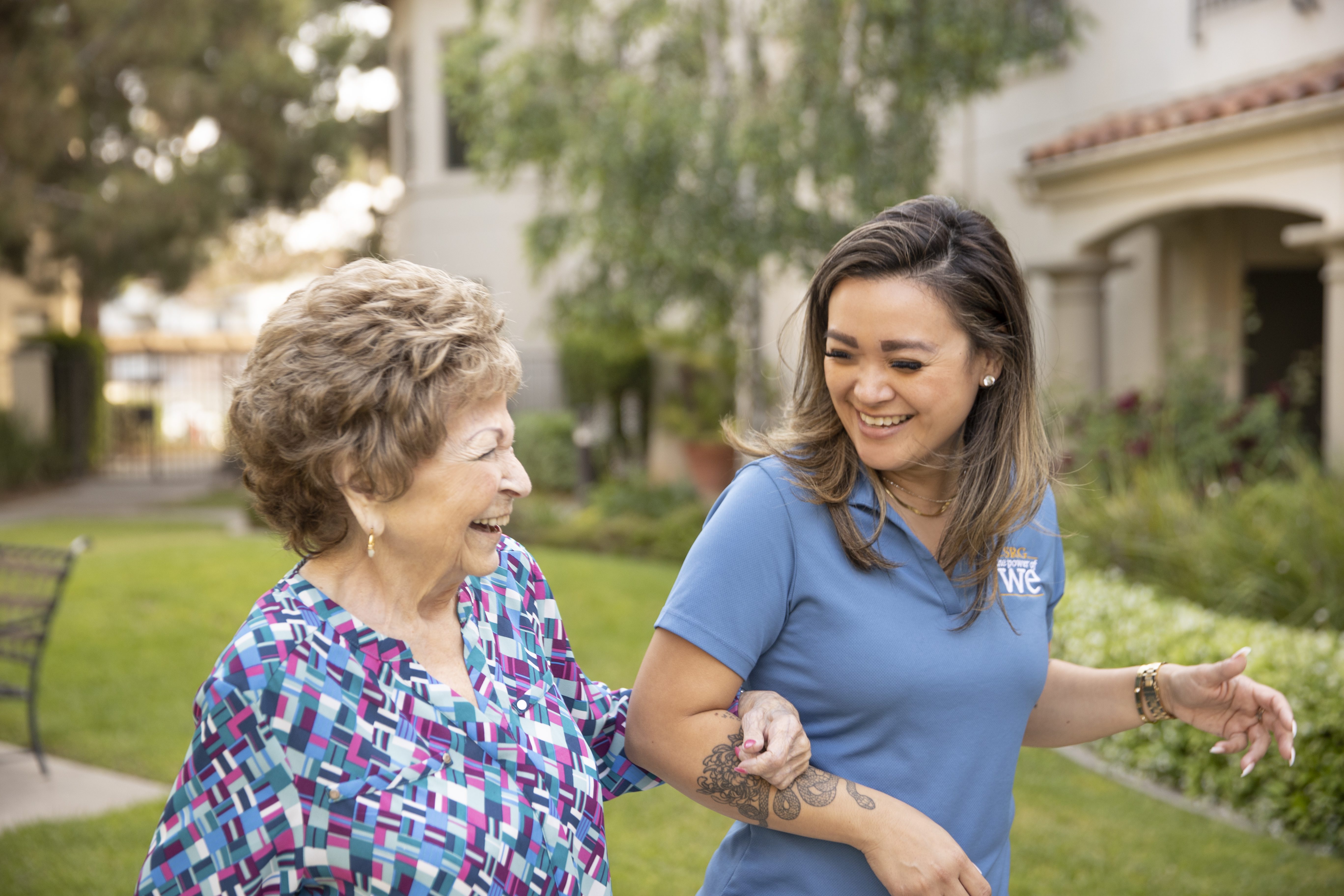 A woman and an older woman walking together, sharing a bond of companionship and support.