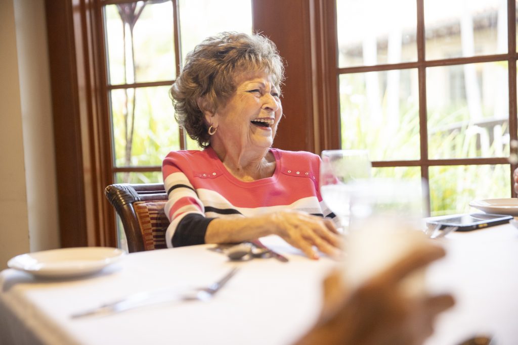 Woman laughing at dinner