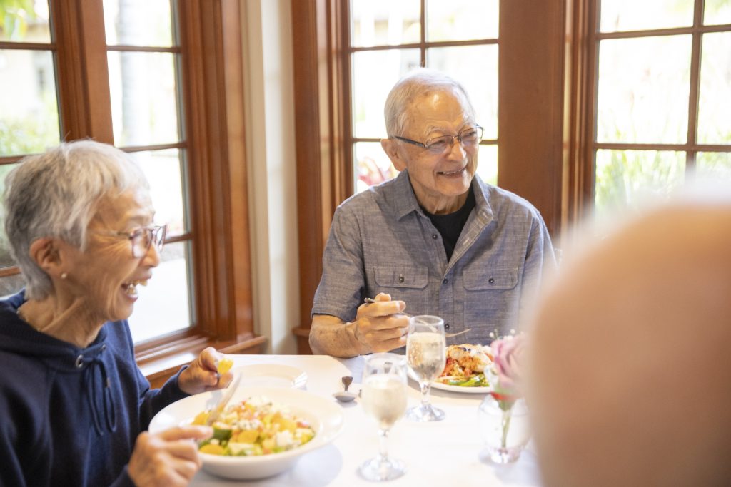 Seniors laughing over dinner