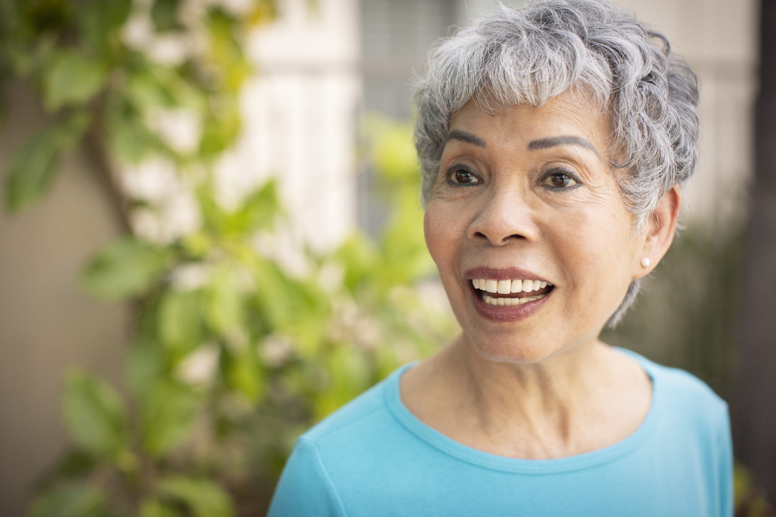 an elderly woman talking with a blue shirt