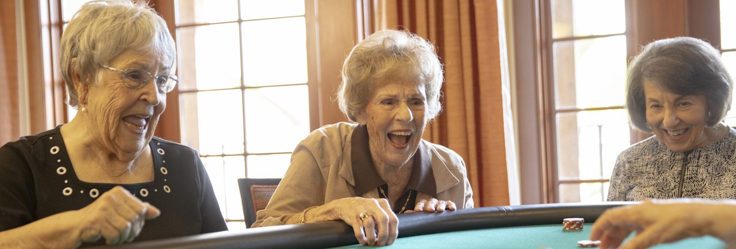 Senior citizens enjoying a variety of casino games, including poker, and roulette