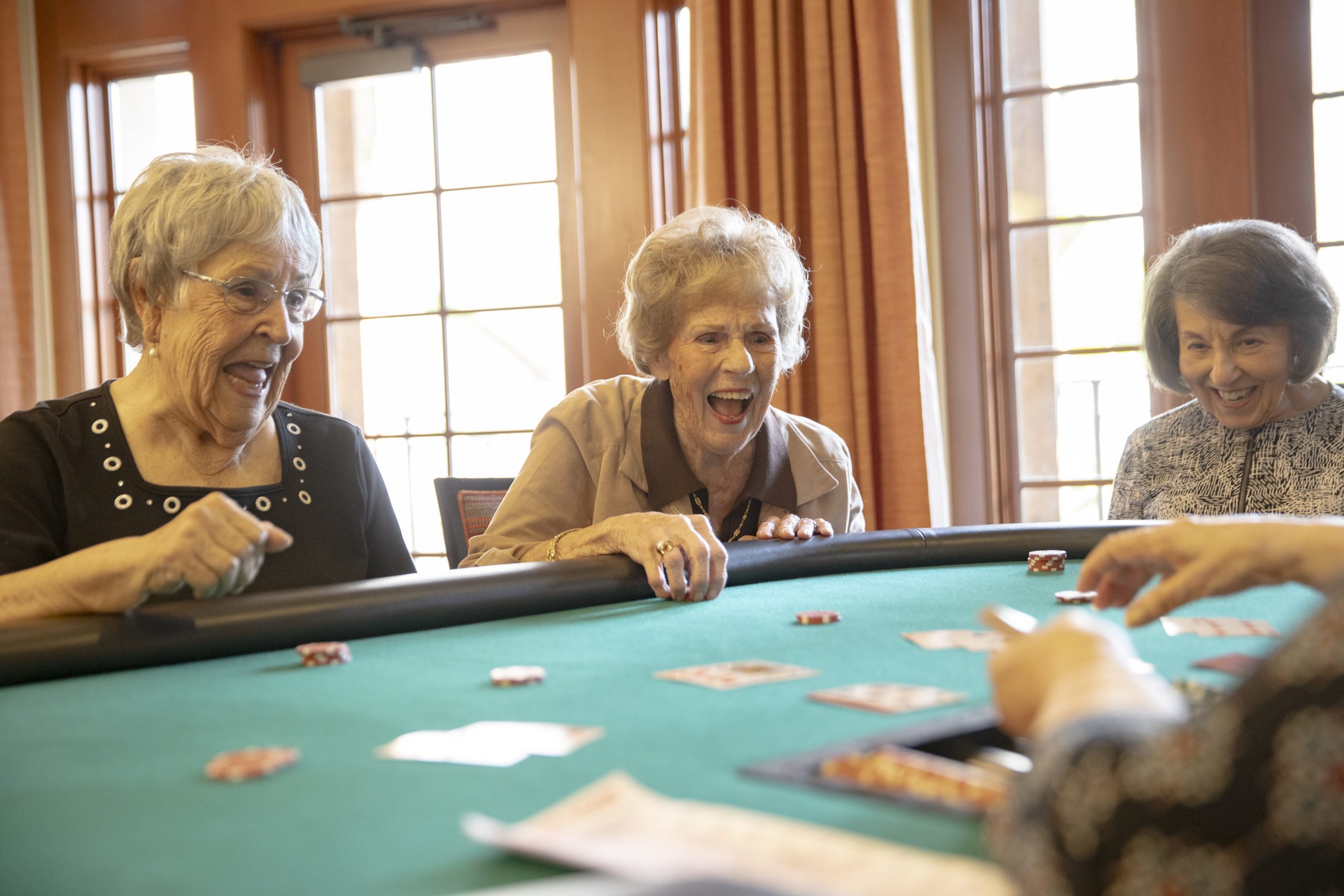 Senior citizens enjoying a variety of casino games, including poker, slot machines, and roulette.