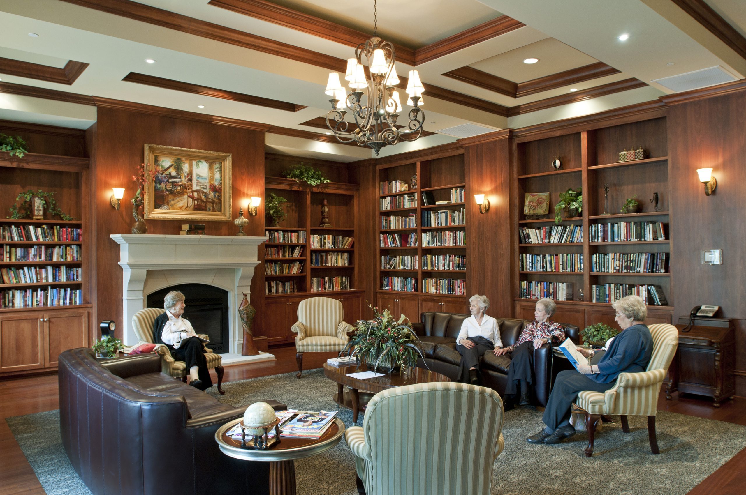 A diverse group of individuals sitting together in a well-lit room, engaged in a discussion or meeting.