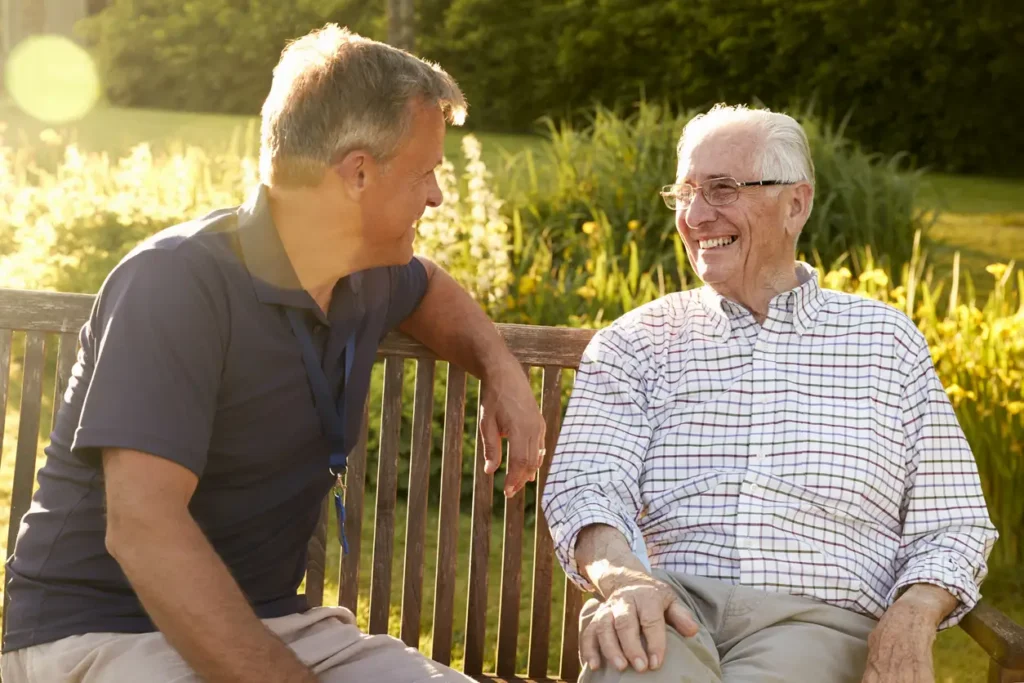 two senior men chatting on a bench
