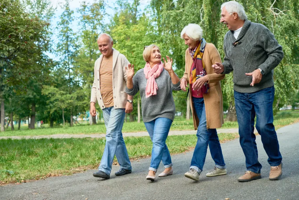 two senior couples on a walk together