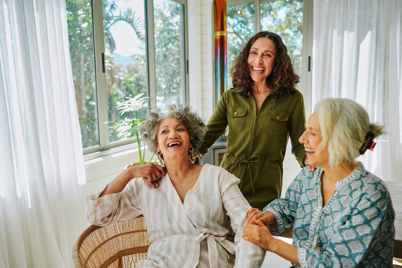 Older women laughing during a visit together by Senior Resource Group