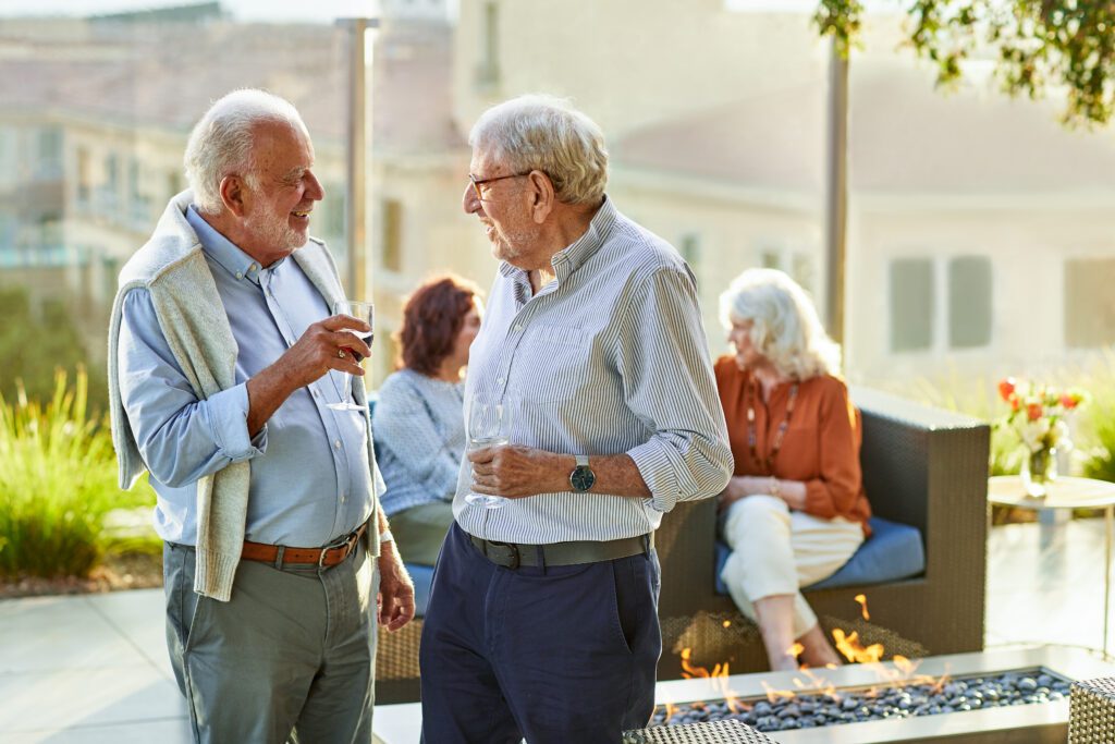 Senior men sharing memories and stories over a glass of wine