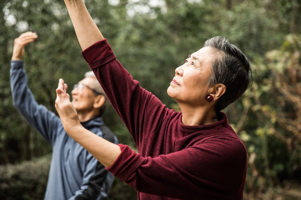 two elderly people doing yoga and staying fit