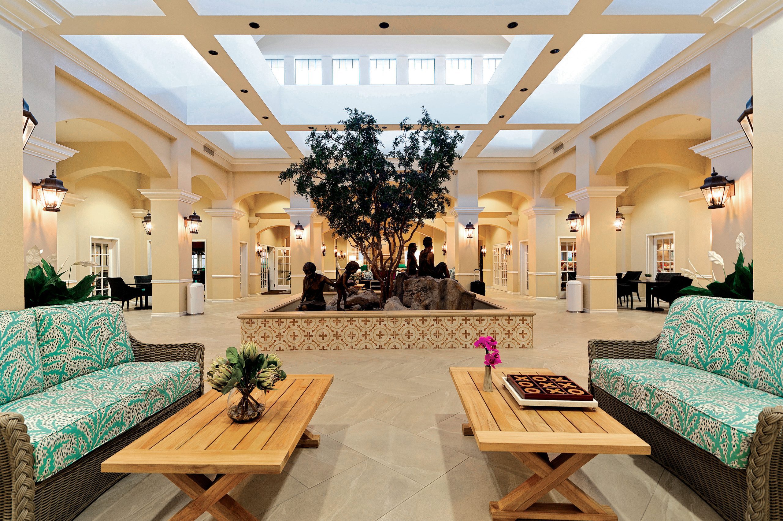 A spacious lobby with comfortable seating arrangements and tables for guests to relax and socialize.