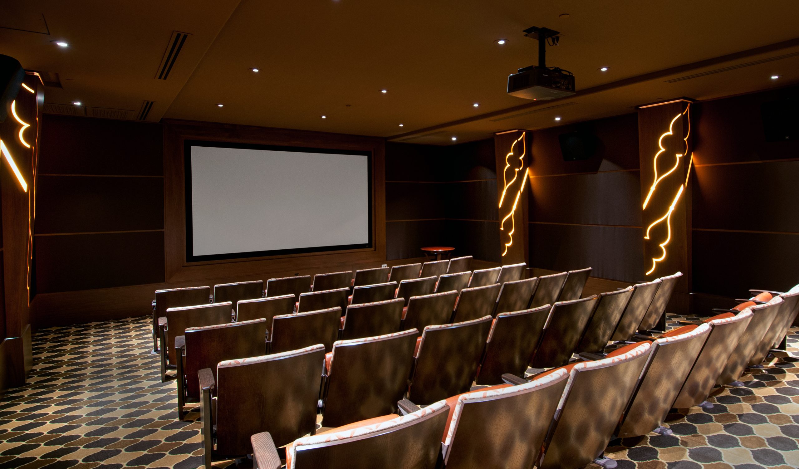 luxury movie theater at retirement community, with several rows of brown seats