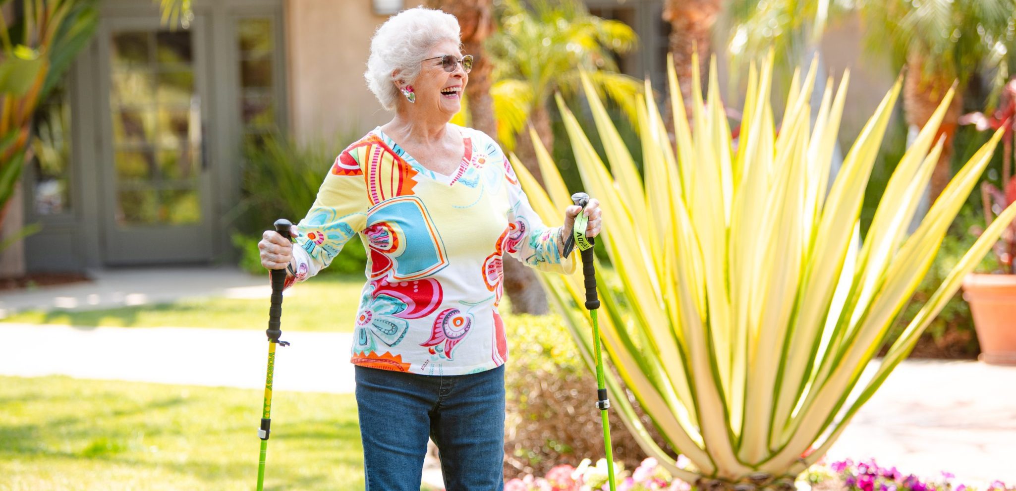 smiling active elderly woman going for a walk with walking sticks