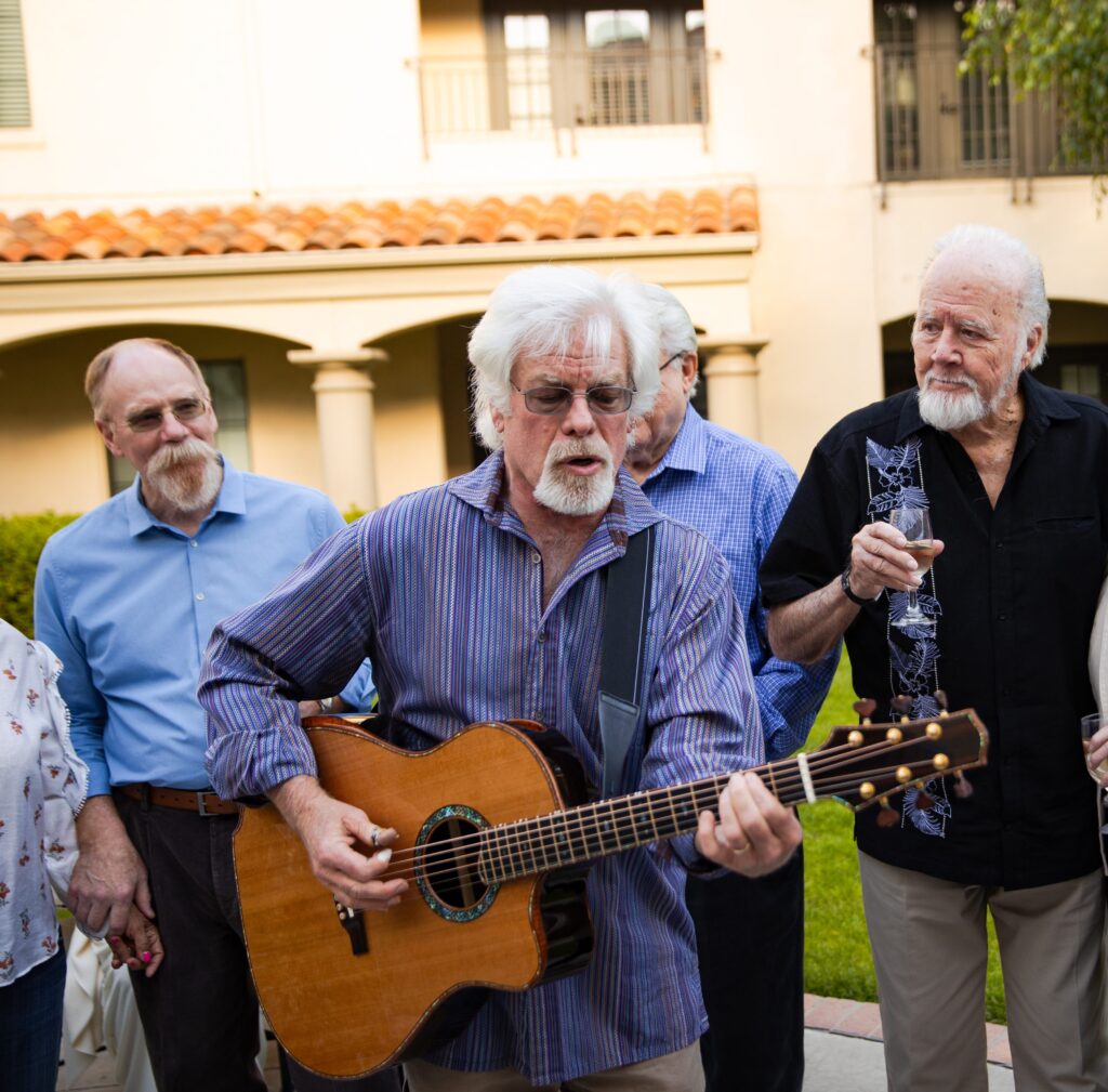 seniors listening to a man playing guitar