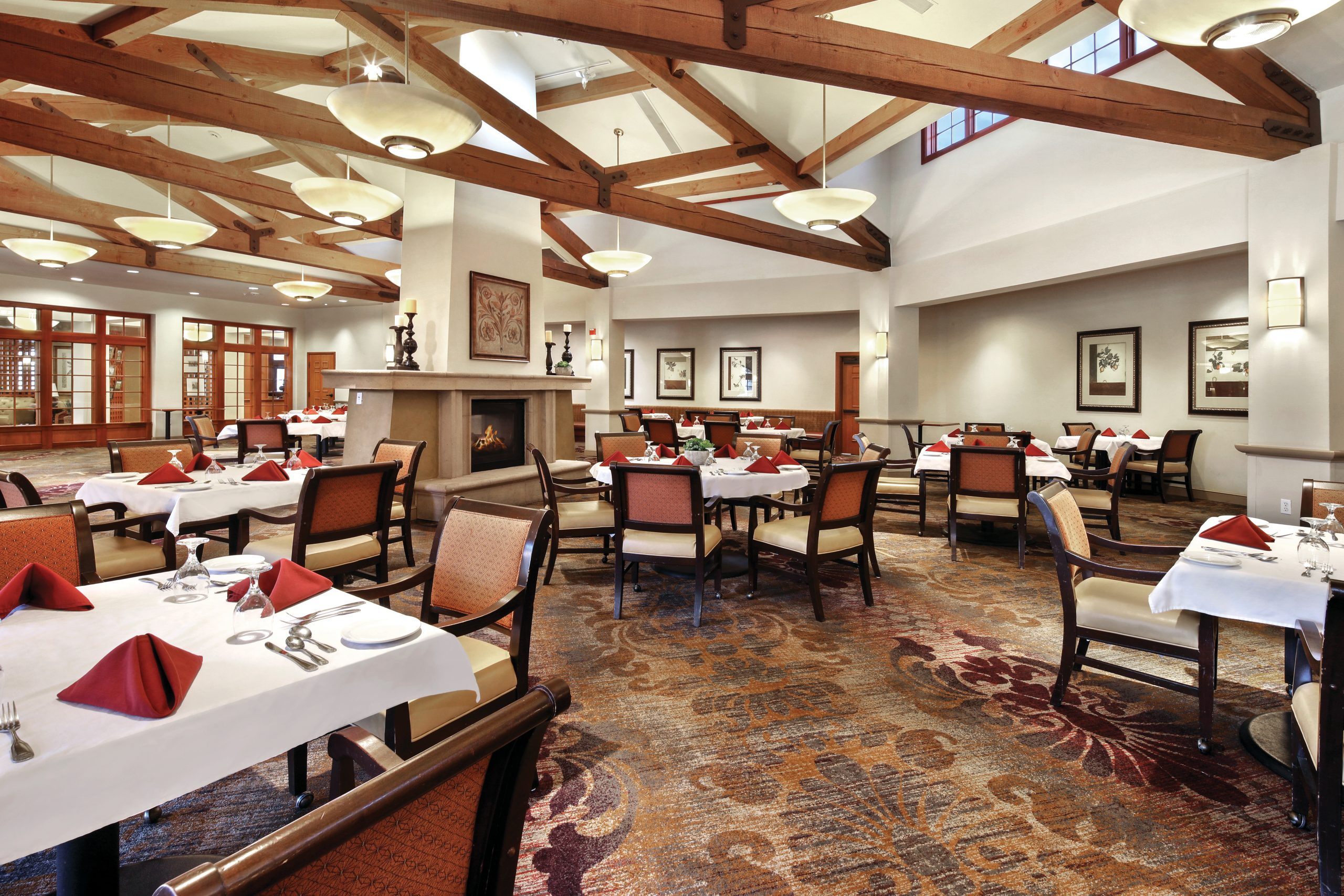 A spacious dining room with neatly arranged tables and chairs for a comfortable dining experience.