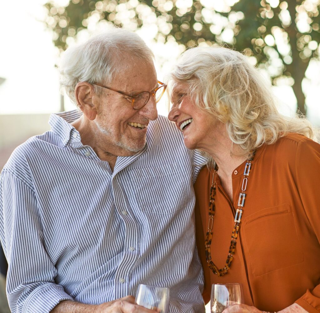 Senior couple sharing romantic moment with a drink