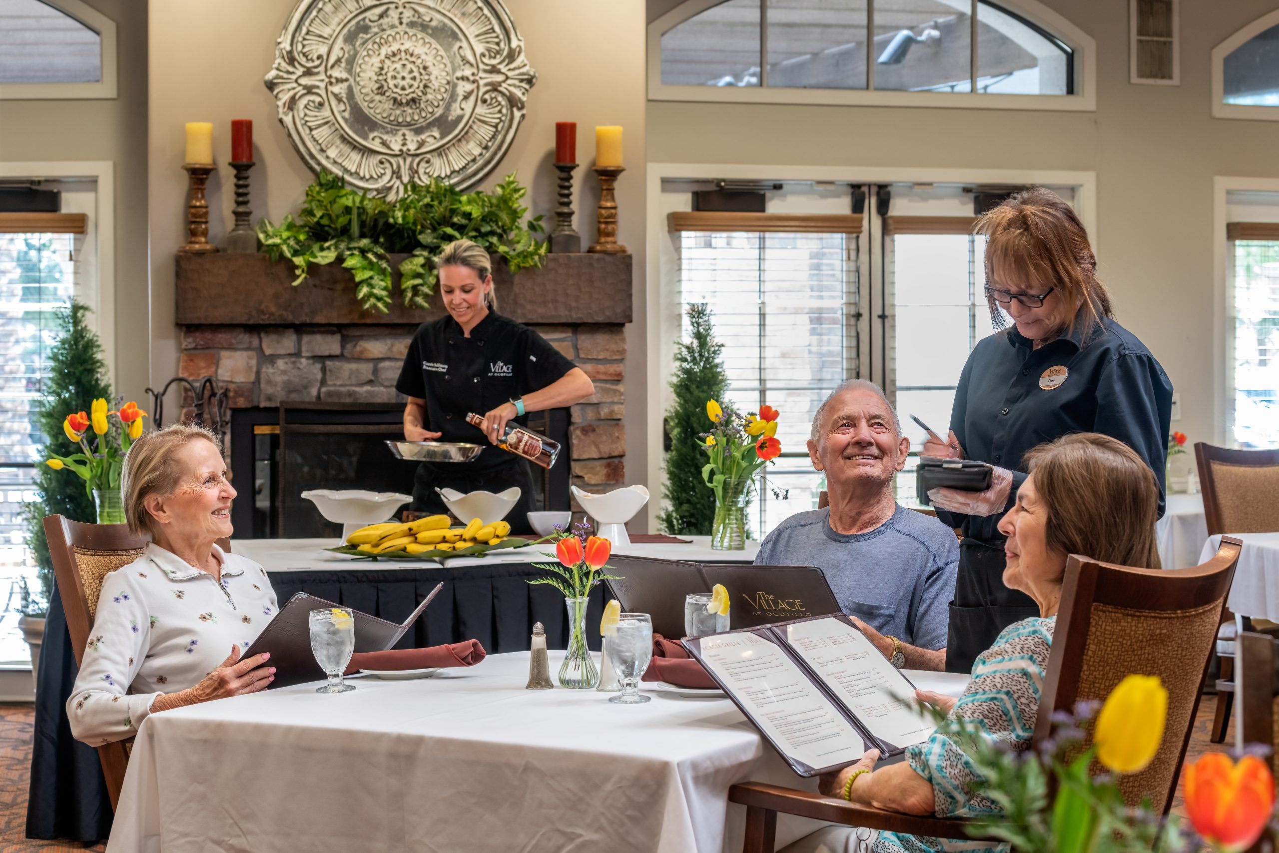 A diverse group of individuals enjoying a meal together at a restaurant table.