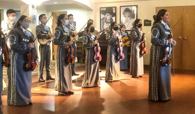 Mariachi band with instruments and a mask