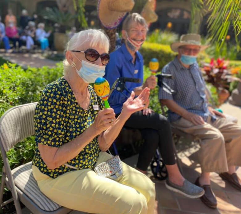 Senior citizens at San Diego Senior Center enjoy a socially distanced visit with friends.