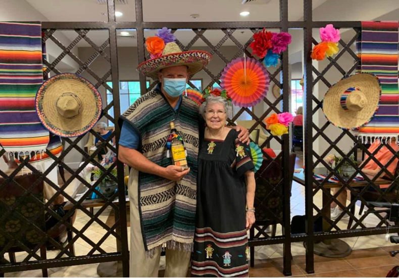 A couple in traditional Mexican attire posing for a photograph.