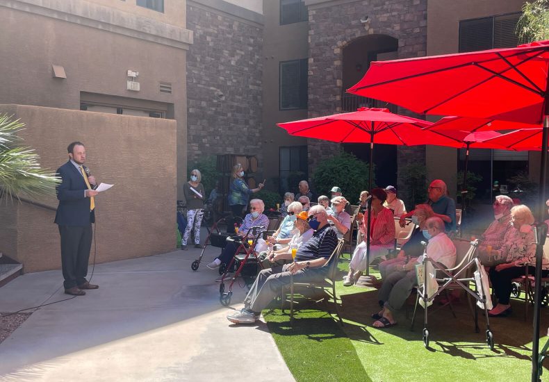 A man addressing a large audience, passionately delivering a speech to captivate and engage the crowd.