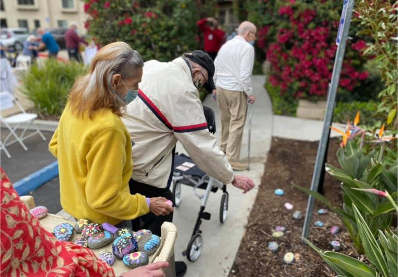 Easter egg hunt at San Diego Zoo: Children searching for colorful eggs hidden among lush greenery and animal exhibits.