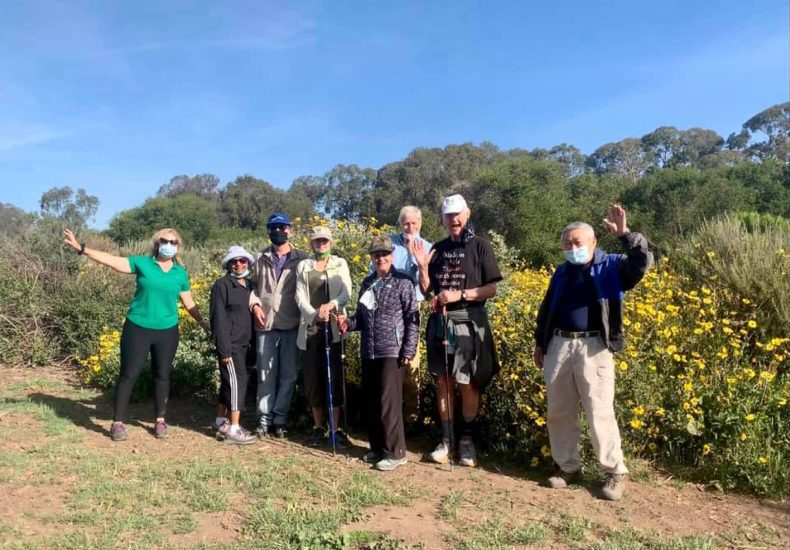 A group of masked individuals standing in a field.