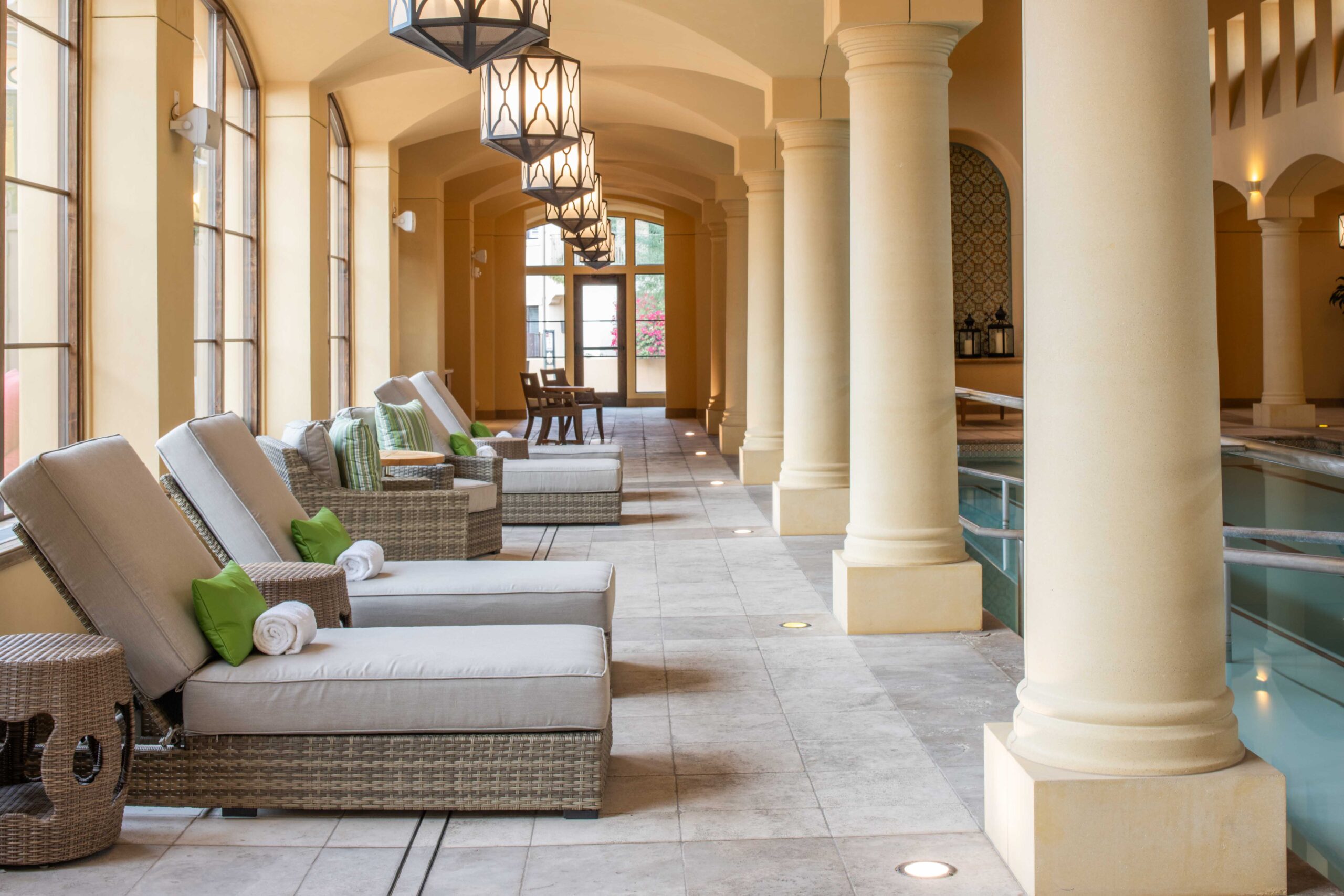 indoor luxurious pool room with tile and columns