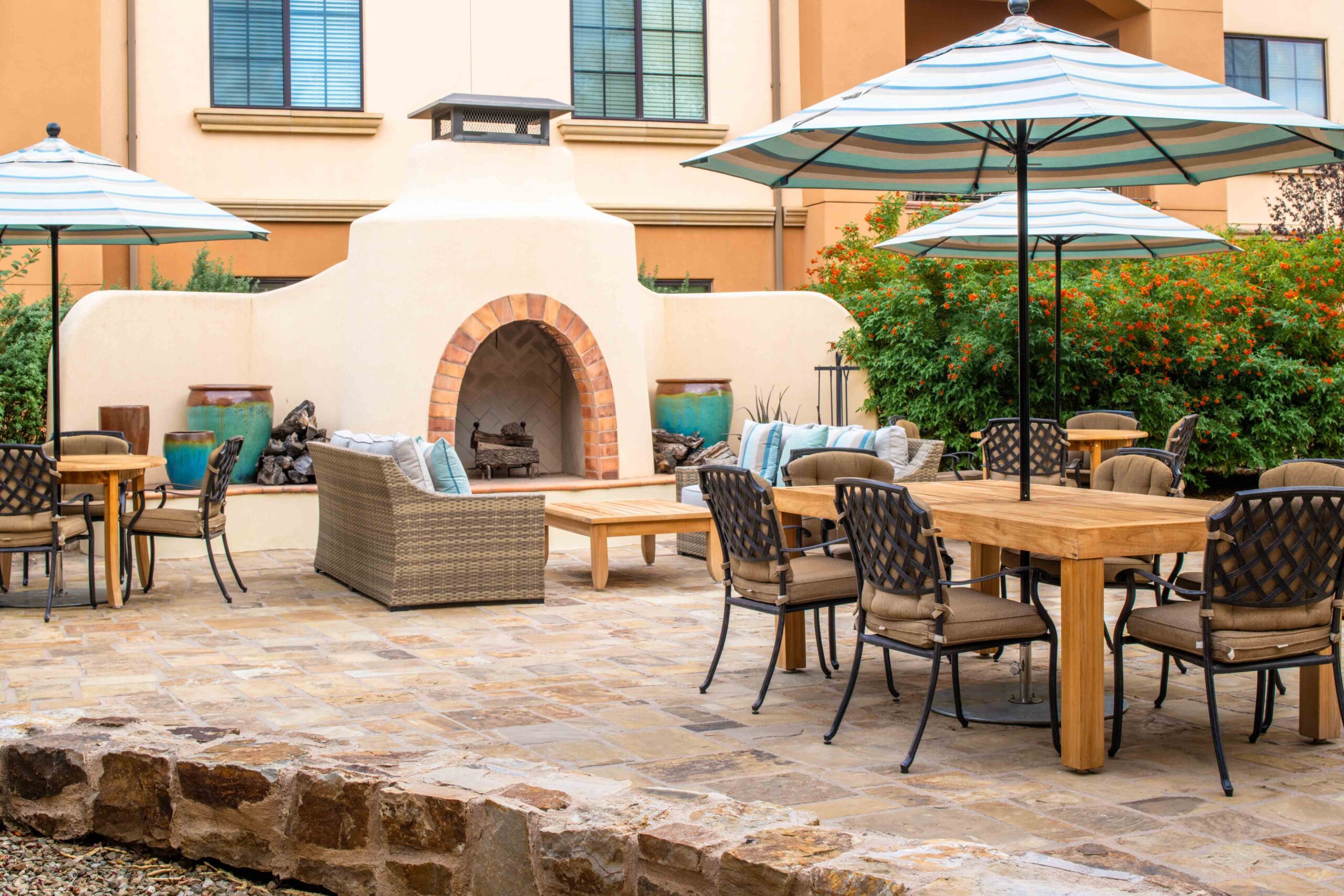 maravilla outdoor patio and fireplace and table with umbrella