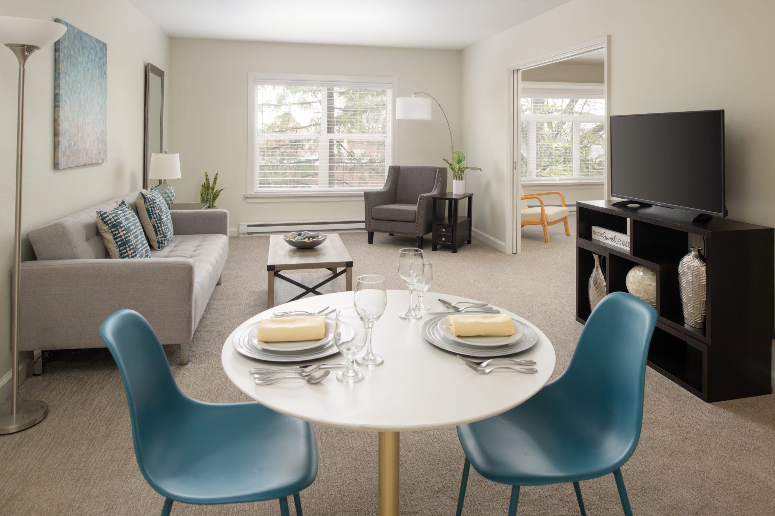 A cozy living room with a stylish dining table and chairs, creating a perfect space for meals and gatherings.