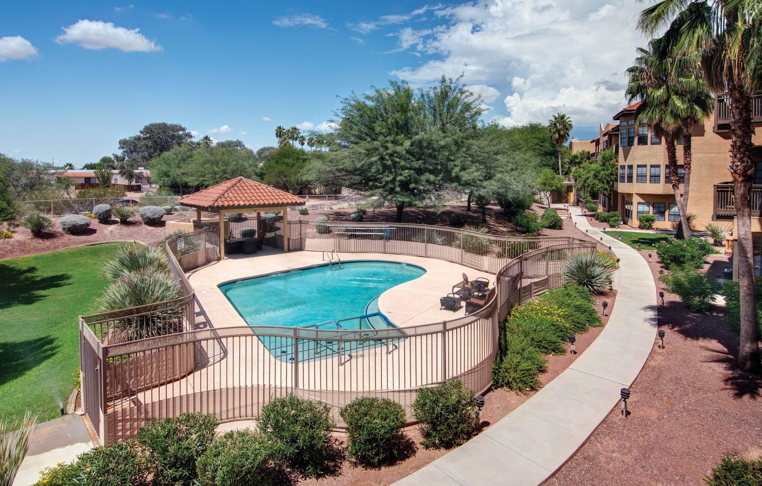 Aerial view of a pool and patio area, offering a serene and inviting outdoor space for relaxation and entertainment.