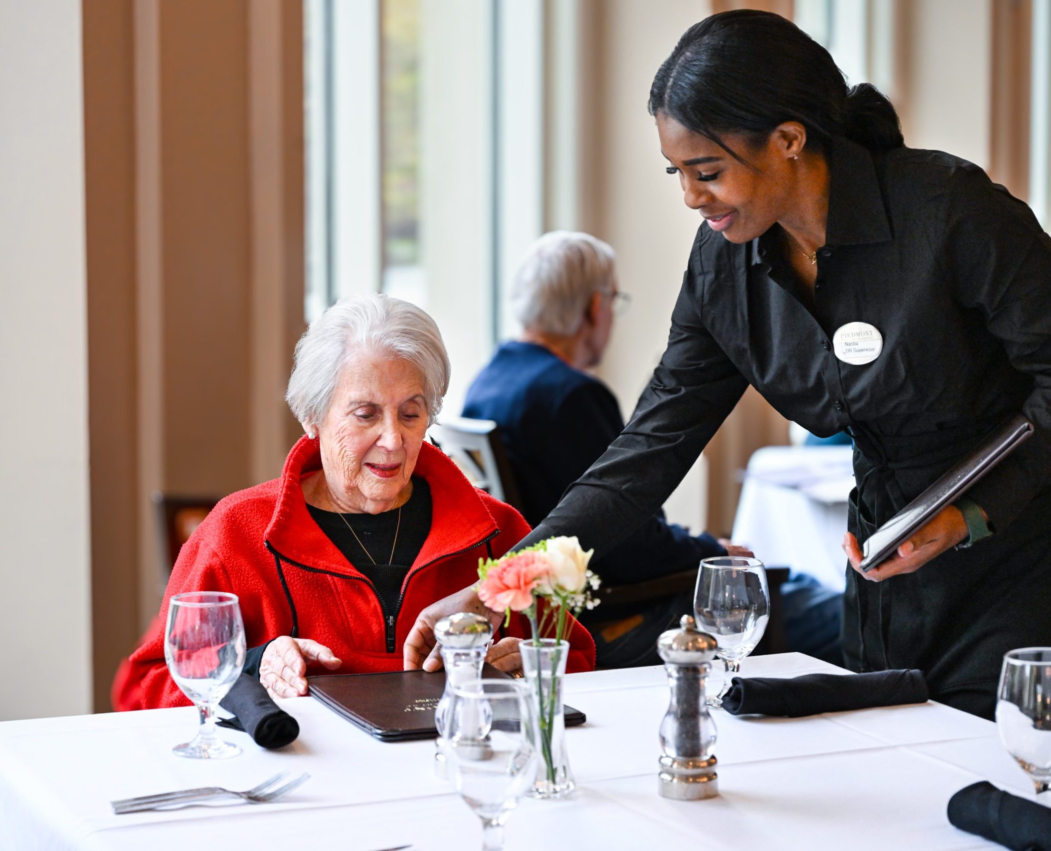 Senior woman being served dinner