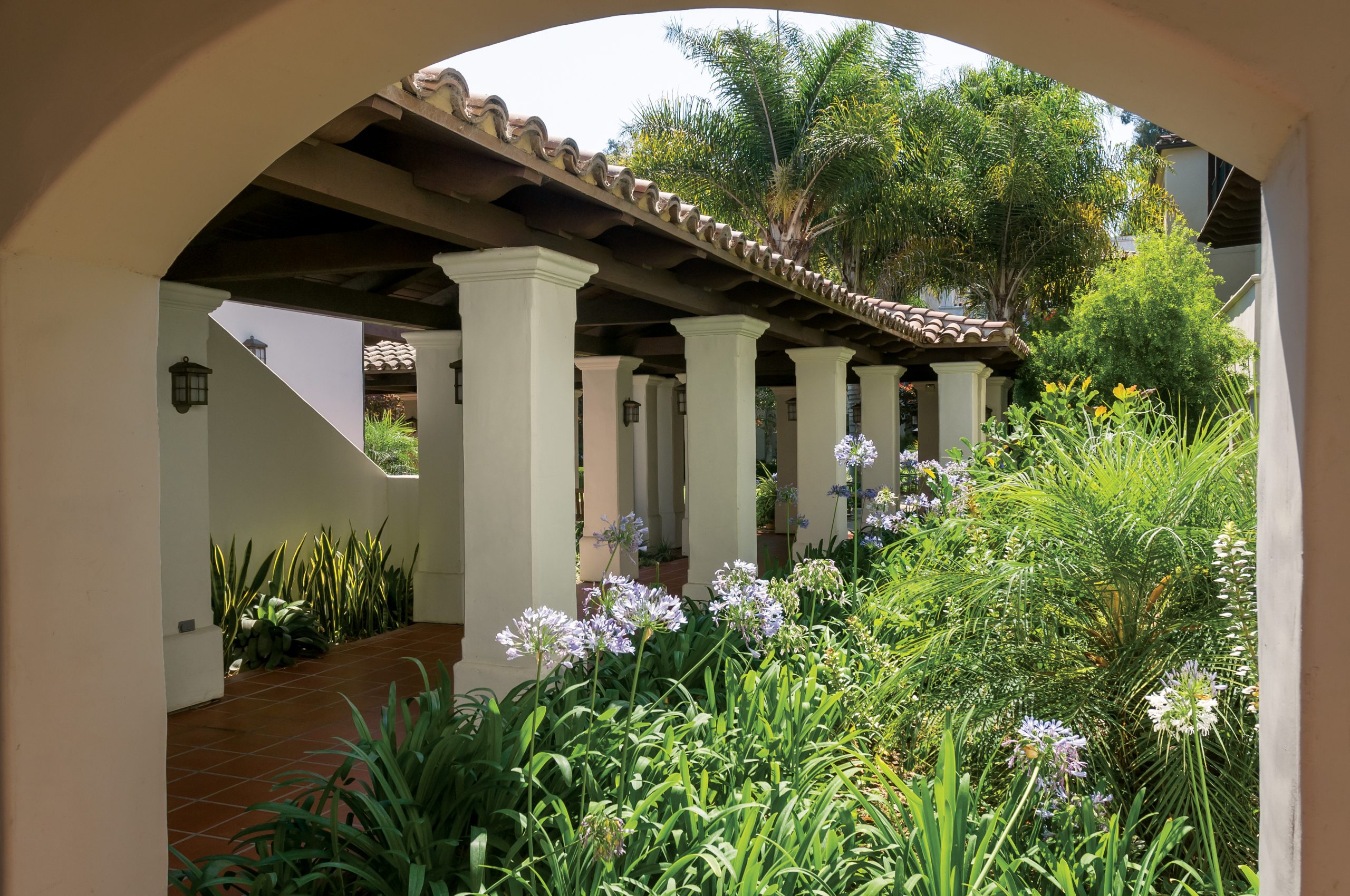 outdoor courtyard with covered walkway with spanish tile
