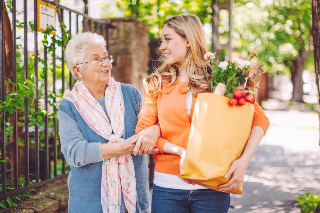 Older adult enjoying a walk with supportive companion outdoors