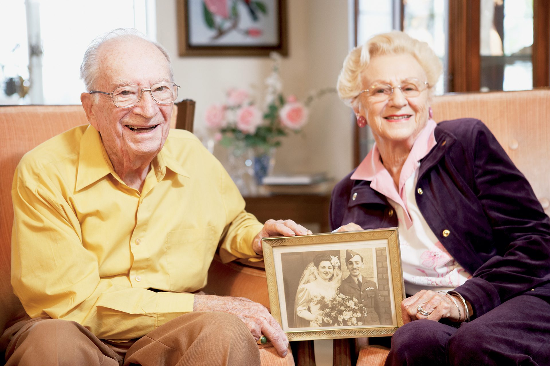 senior couple holding up marriage photo