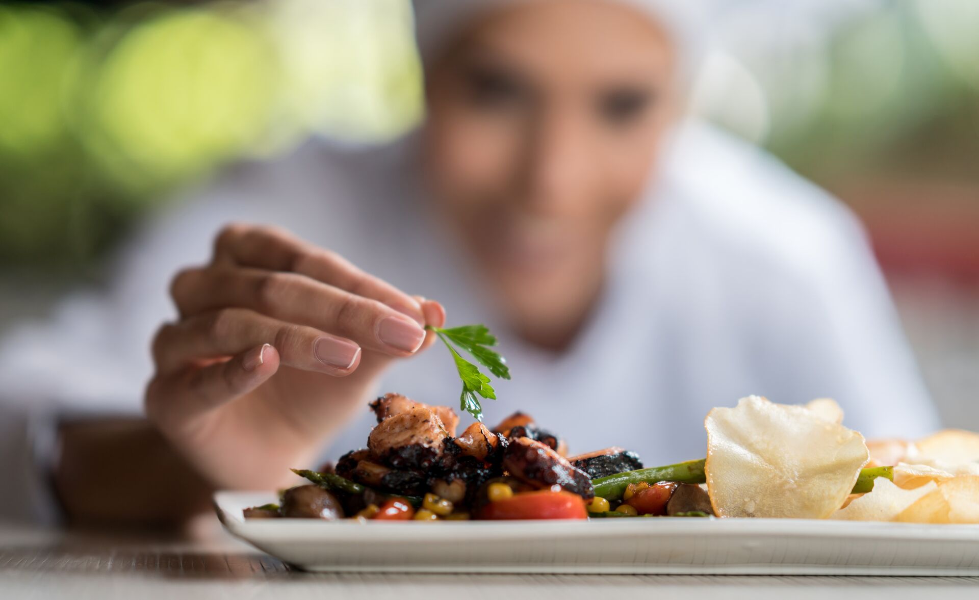 chef garnishing fine dining meal