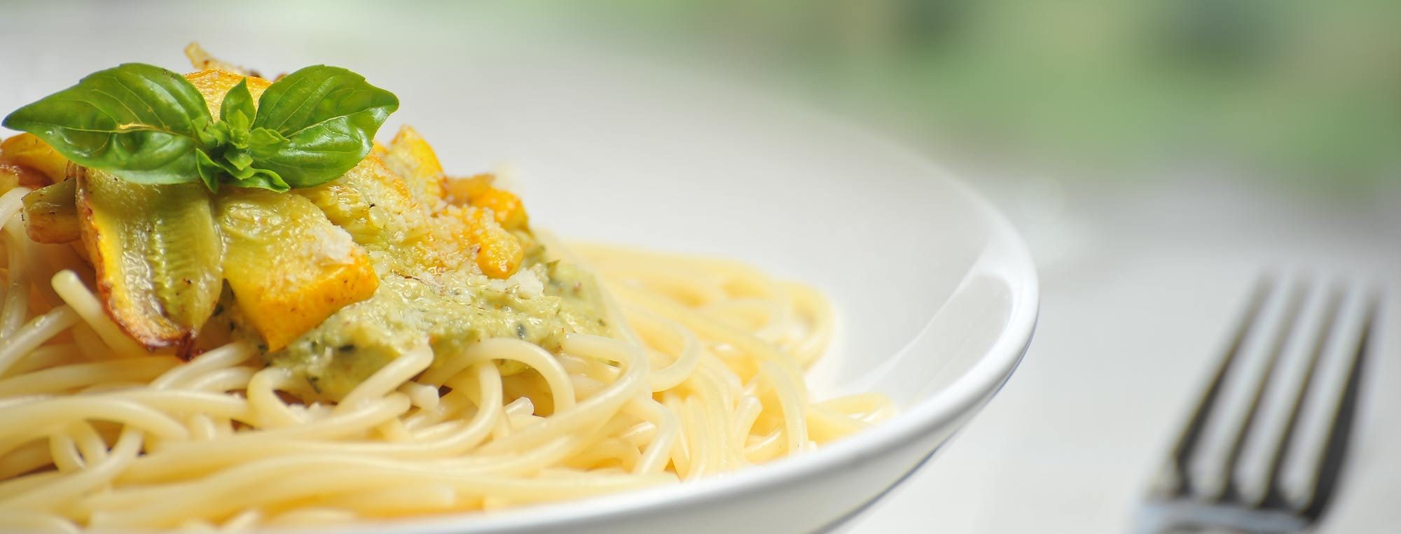 dinner of spaghetti with pesto and basil