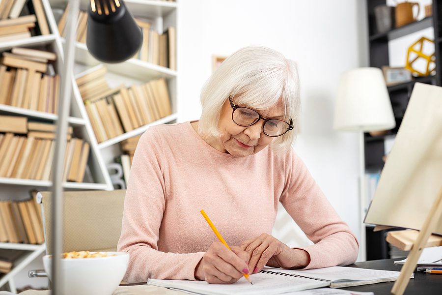 Senior woman writes down New Year’s Resolutions ahead of 2026
