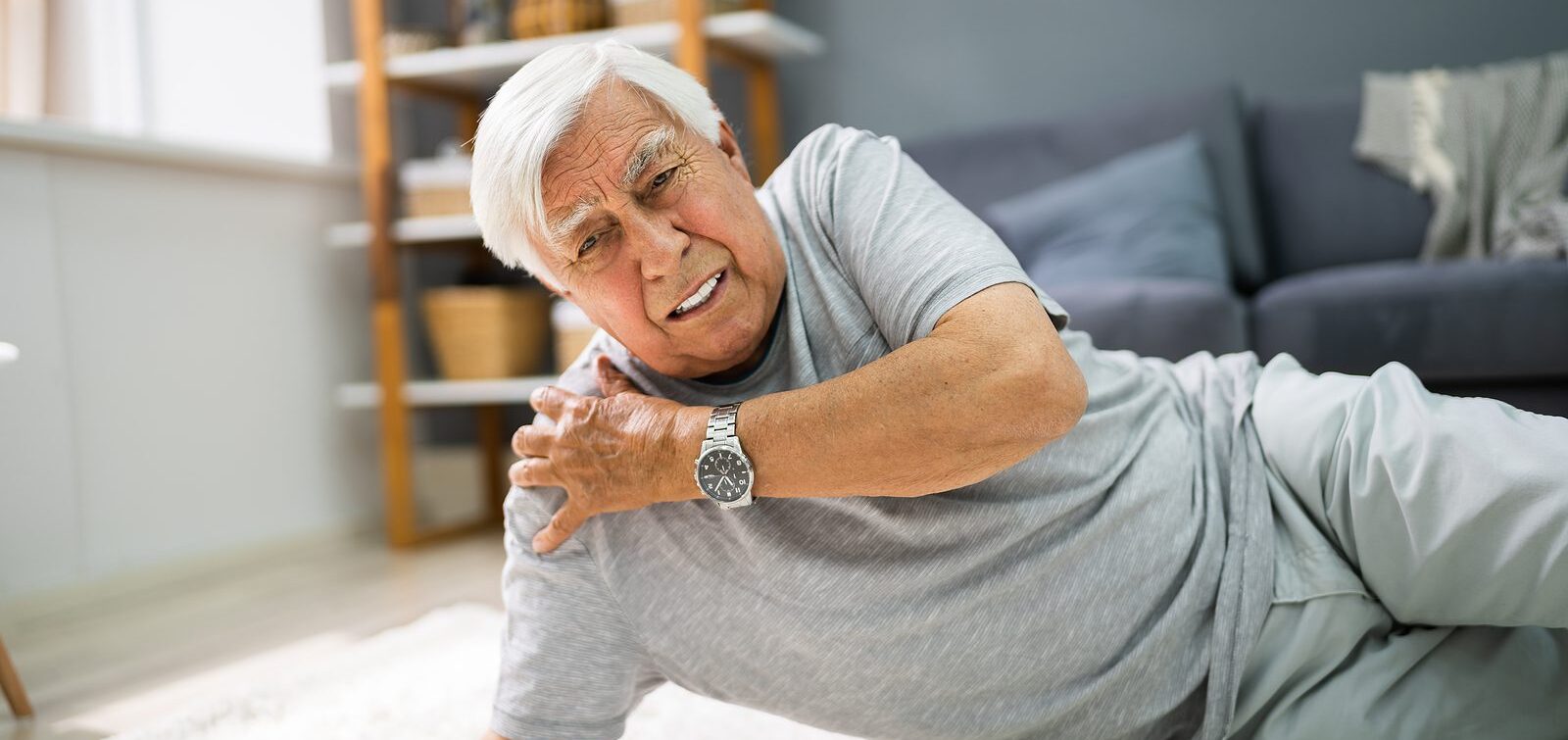 Senior man lying on a carpeted floor after falling Senior man lying on a carpeted floor after falling