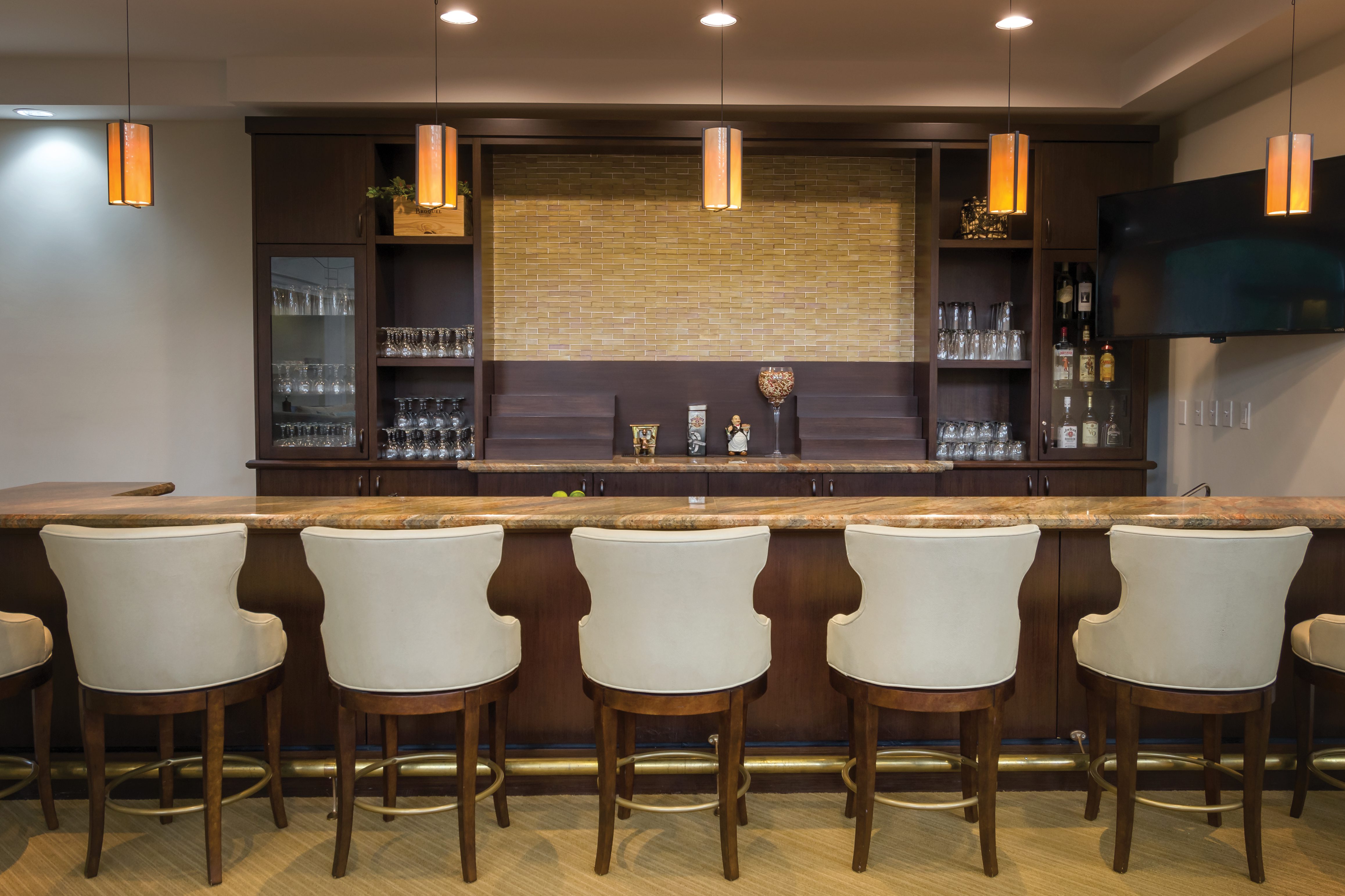 Clubhouse Bar at the Carlisle naples, with bar stools and dark wood